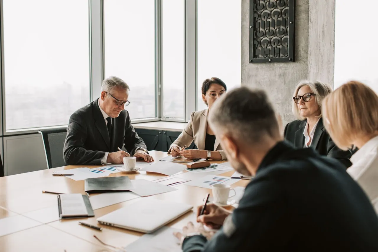 Business advisors reviewing documents around a boardroom table